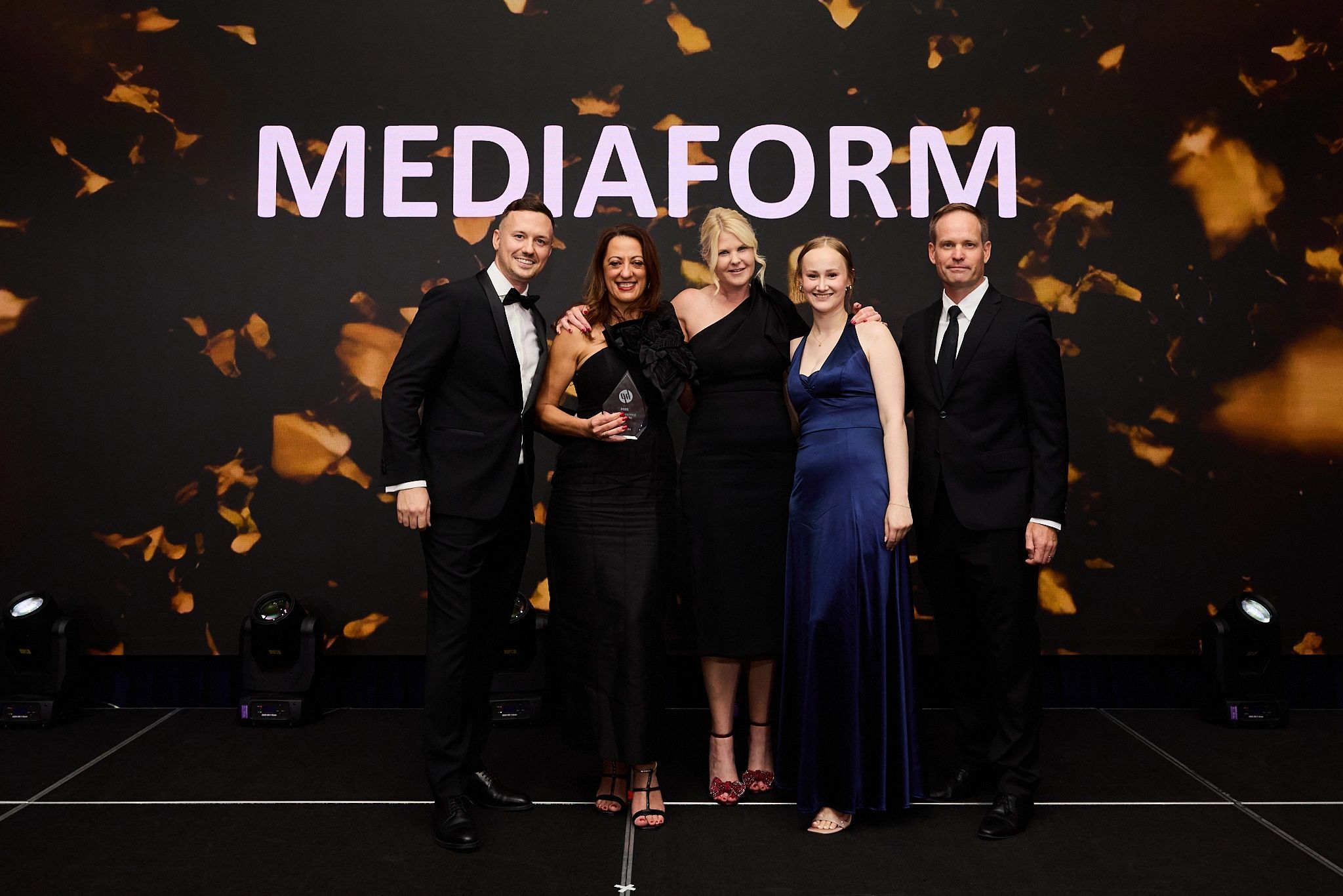 MediaForm staff on stage accepting Supplies Partner of the Year award